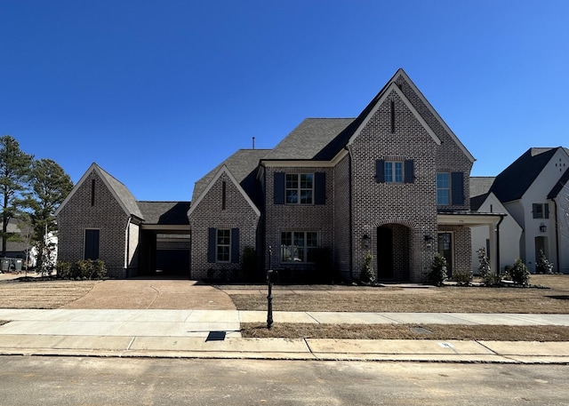 view of front of house featuring concrete driveway and brick siding