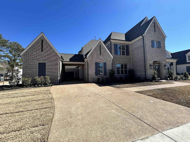 view of front of home featuring driveway and brick siding