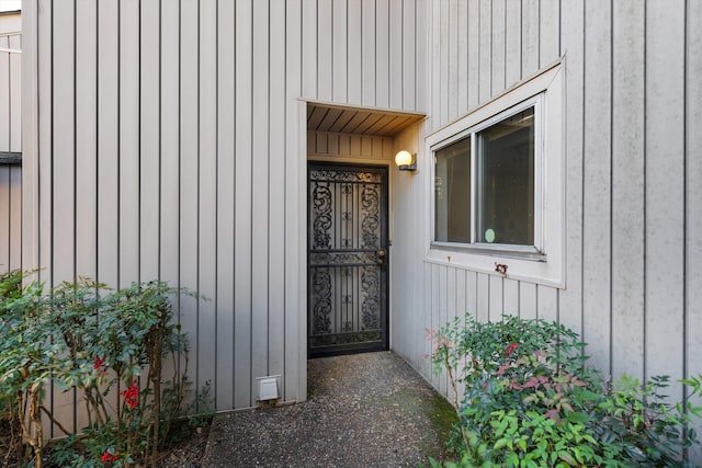 view of exterior entry featuring board and batten siding