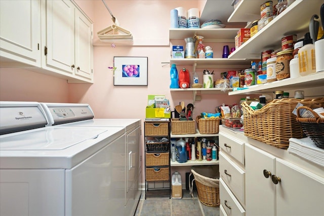 clothes washing area featuring washing machine and clothes dryer and cabinet space