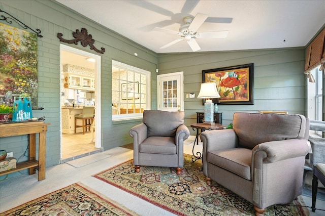 sitting room with light colored carpet and ceiling fan