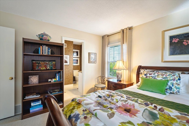 bedroom with carpet floors and ensuite bathroom