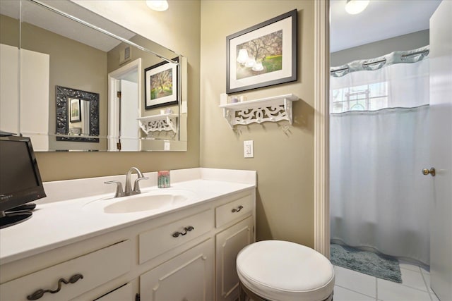 bathroom with a shower with curtain, vanity, toilet, and tile patterned floors