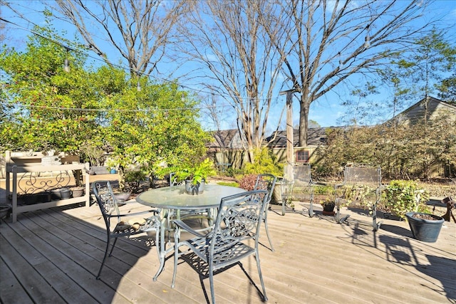 deck featuring outdoor dining area and fence