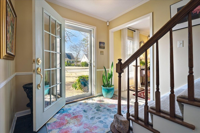 doorway with crown molding and stairway