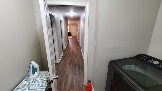 clothes washing area with laundry area, baseboards, washer / clothes dryer, and wood finished floors