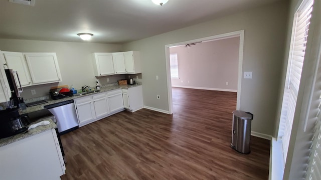 kitchen with baseboards, dark wood-style flooring, white cabinets, and dishwasher