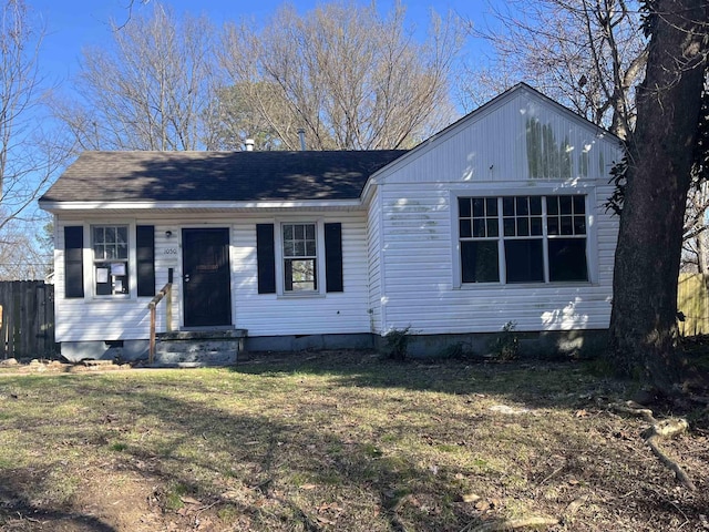 view of front of property featuring entry steps, crawl space, roof with shingles, and a front yard