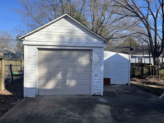 detached garage featuring fence