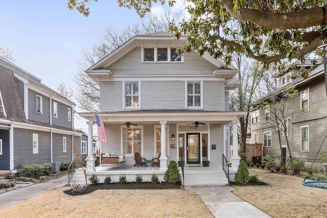 traditional style home featuring ceiling fan, a porch, and a front yard