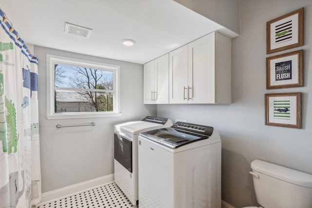 washroom with washer and dryer, visible vents, and baseboards