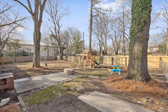 view of yard with a playground and a fenced backyard