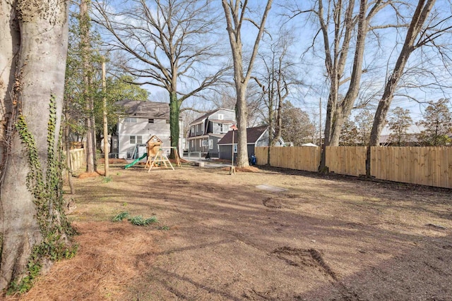 view of yard featuring a playground and fence