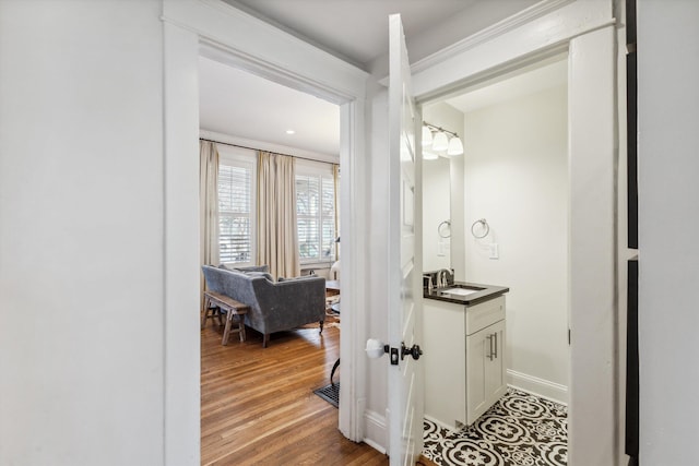 bathroom with vanity, baseboards, and wood finished floors