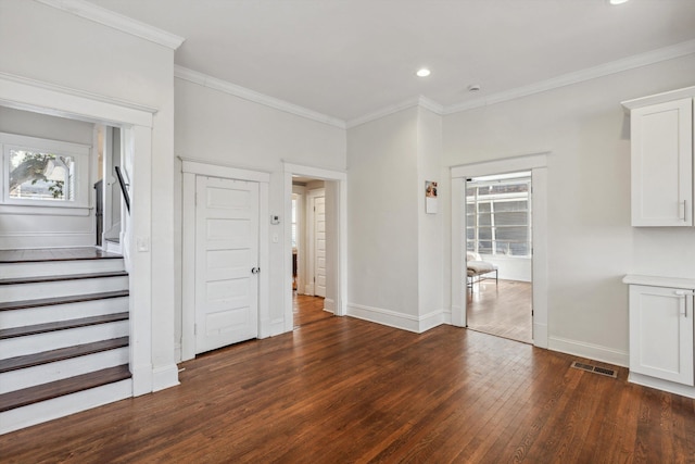 interior space featuring crown molding, visible vents, stairway, dark wood-type flooring, and baseboards