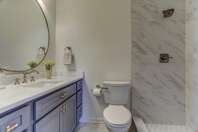 full bath with toilet, marble finish floor, tiled shower, and vanity