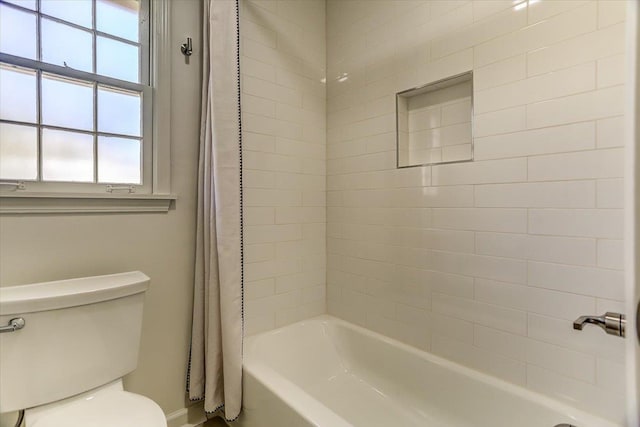 bathroom with shower / bath combo with shower curtain and toilet