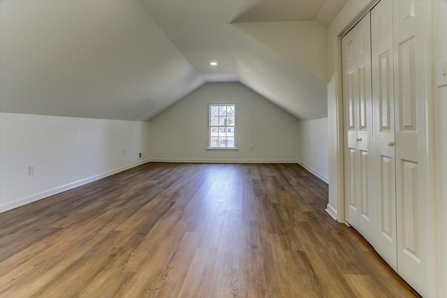 bonus room featuring vaulted ceiling, wood finished floors, and baseboards