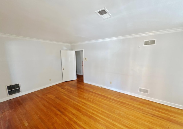 empty room with visible vents and wood finished floors