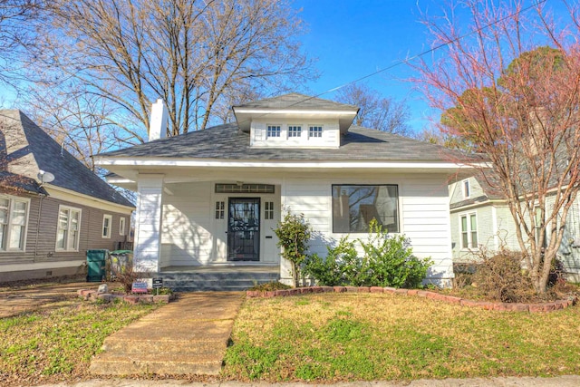 bungalow-style house featuring a front lawn