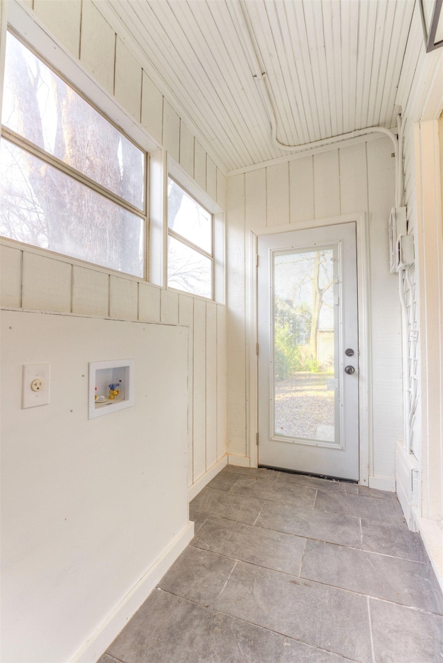 interior space featuring hookup for a washing machine, laundry area, electric dryer hookup, and baseboards