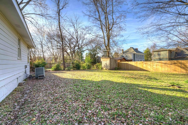 view of yard featuring a fenced backyard, an outdoor structure, and a storage shed