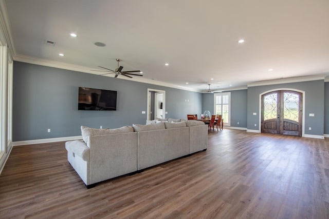 living room with french doors, visible vents, baseboards, and wood finished floors