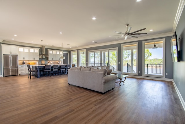 living area with baseboards, dark wood-type flooring, and recessed lighting