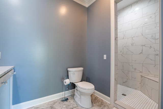 bathroom with marble finish floor, tiled shower, toilet, and baseboards