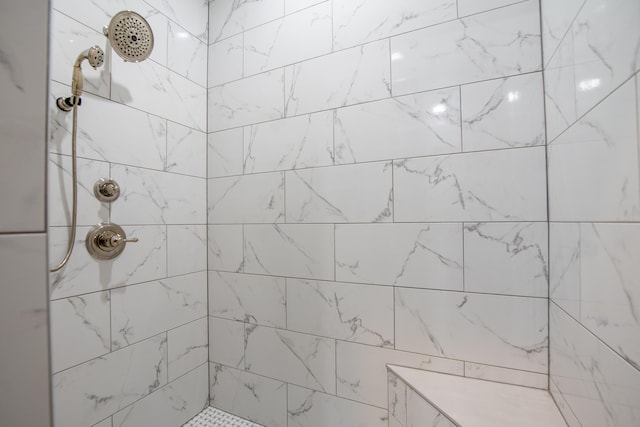 full bath with tiled shower