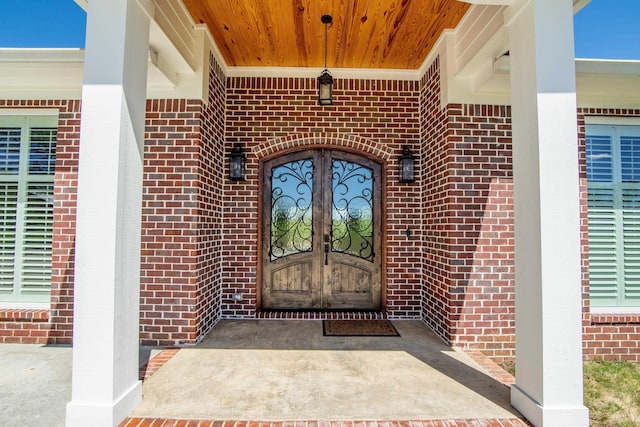 doorway to property featuring brick siding