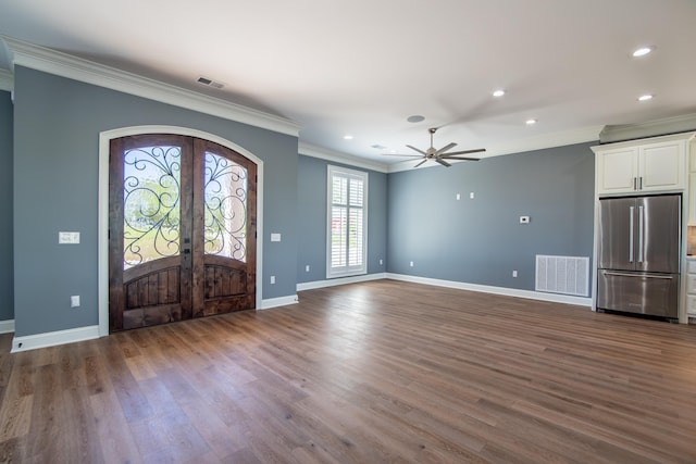 foyer entrance featuring french doors, visible vents, crown molding, and wood finished floors