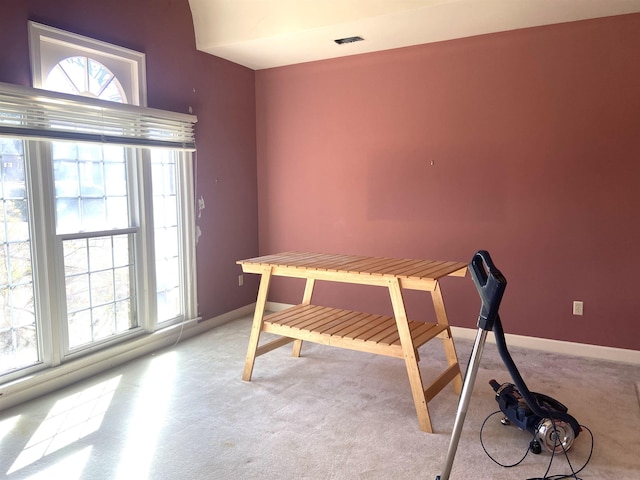 office with visible vents, plenty of natural light, light carpet, and baseboards