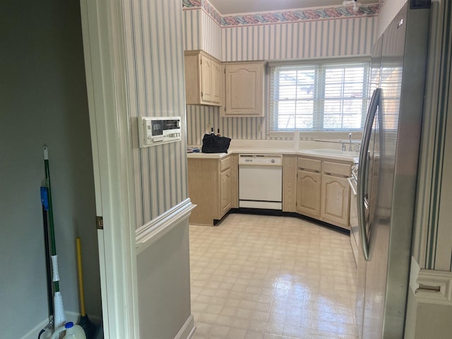 kitchen featuring wallpapered walls, dishwasher, freestanding refrigerator, light countertops, and light floors