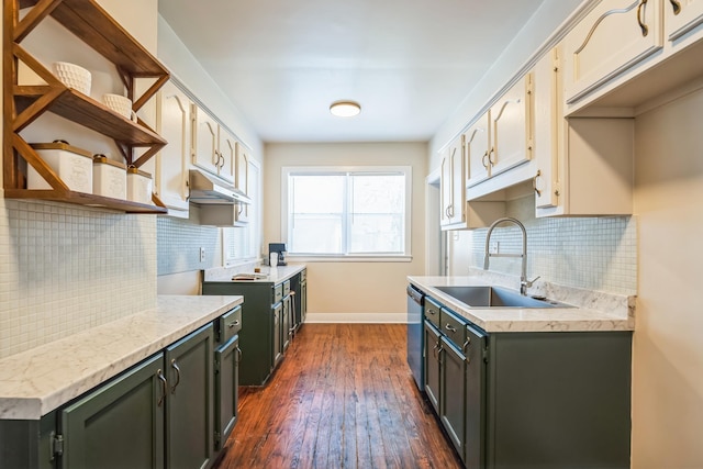 kitchen with dark wood-style flooring, a sink, light countertops, stainless steel dishwasher, and open shelves