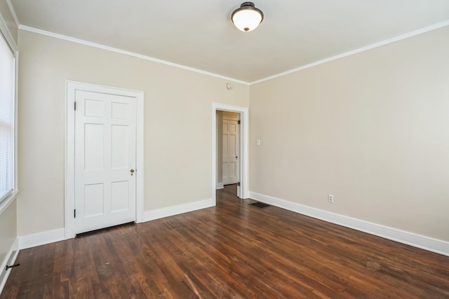 unfurnished bedroom with baseboards, dark wood-style floors, and crown molding