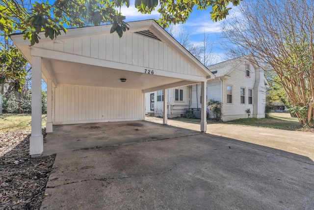 view of front of property featuring driveway and an attached carport