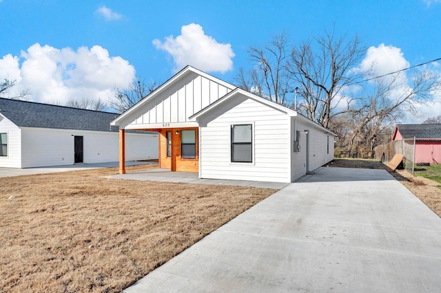 view of front of home with board and batten siding and a front yard