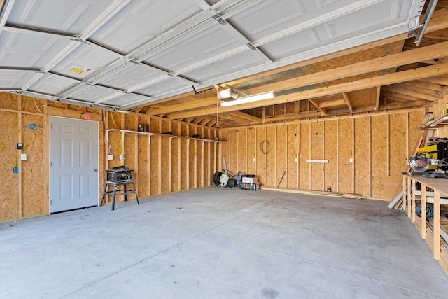 garage featuring a workshop area and a garage door opener