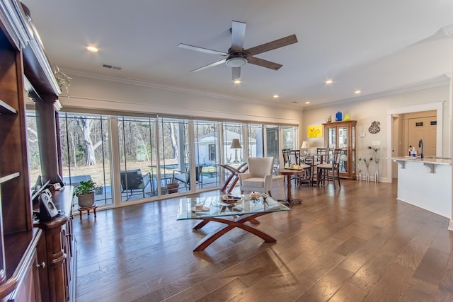 living area with dark wood-type flooring, visible vents, and plenty of natural light