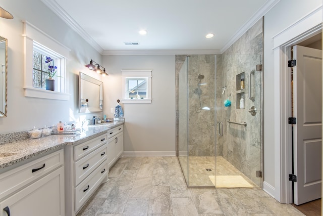 bathroom featuring vanity, baseboards, visible vents, a stall shower, and crown molding