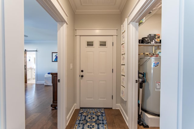 foyer with a barn door, ornamental molding, dark wood-type flooring, and gas water heater