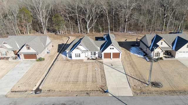 birds eye view of property with a wooded view