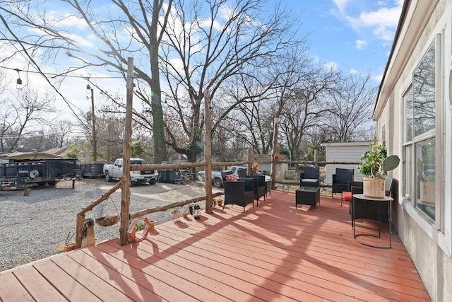 wooden terrace with fence and an outdoor living space