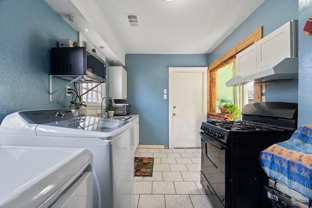 laundry room featuring a textured wall, laundry area, a sink, visible vents, and washer and dryer