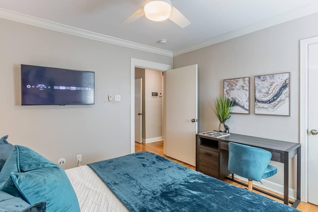 bedroom with ceiling fan, ornamental molding, baseboards, and light wood-style floors