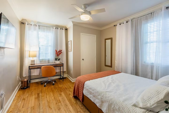 bedroom featuring light wood-style floors, crown molding, baseboards, and ceiling fan