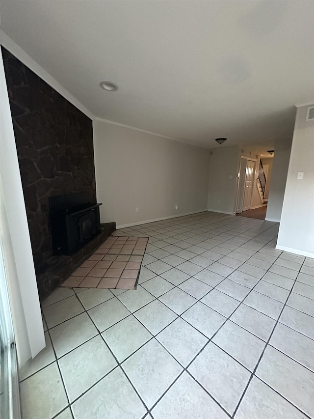 unfurnished living room with visible vents, stairs, baseboards, and light tile patterned flooring