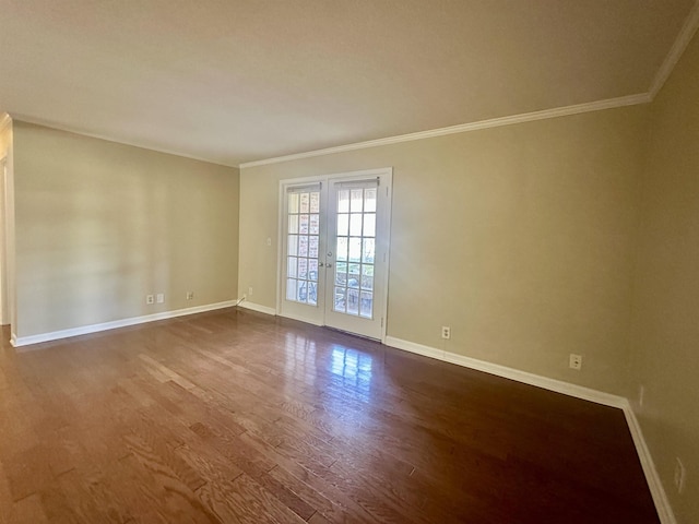 empty room featuring crown molding, baseboards, wood finished floors, and french doors