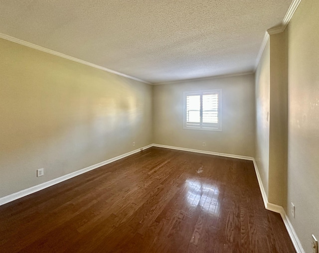 empty room featuring ornamental molding, dark wood-style flooring, a textured ceiling, and baseboards